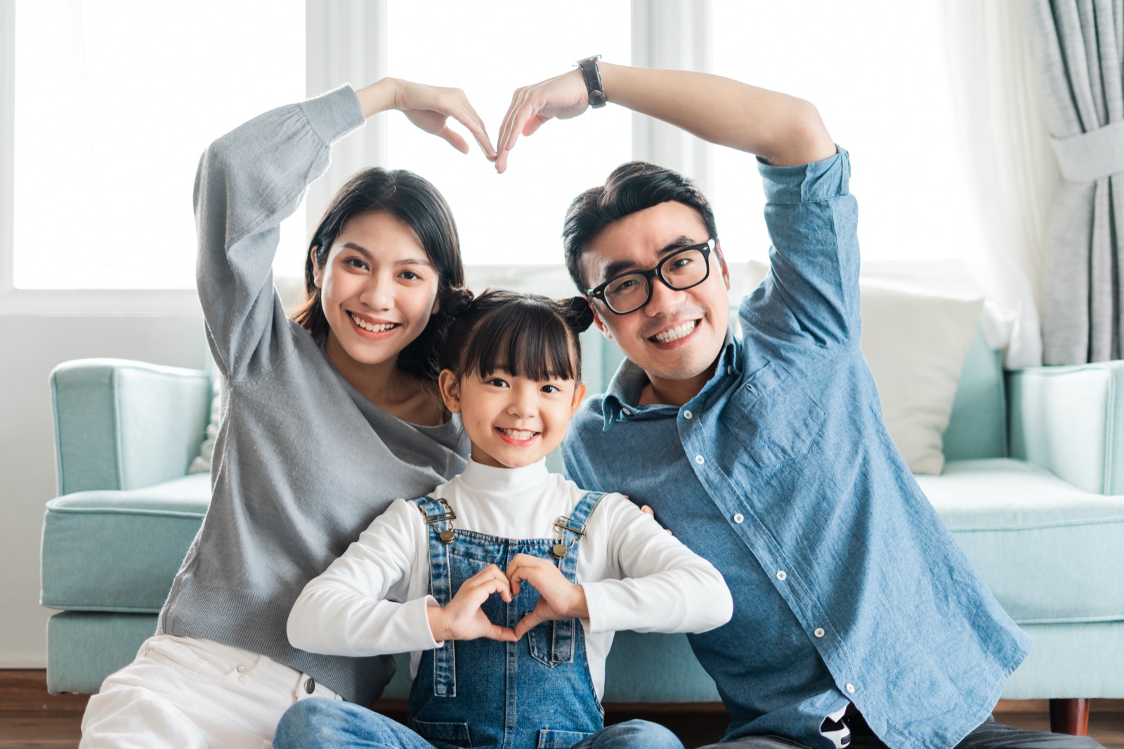 Family making a heart with their hands